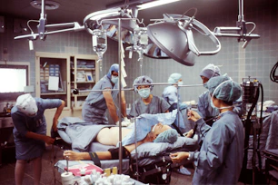 Doctors and nurses collaborating in a well-equipped operating room.