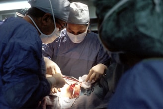 A surgeon performing a laparoscopic procedure in an operating room.