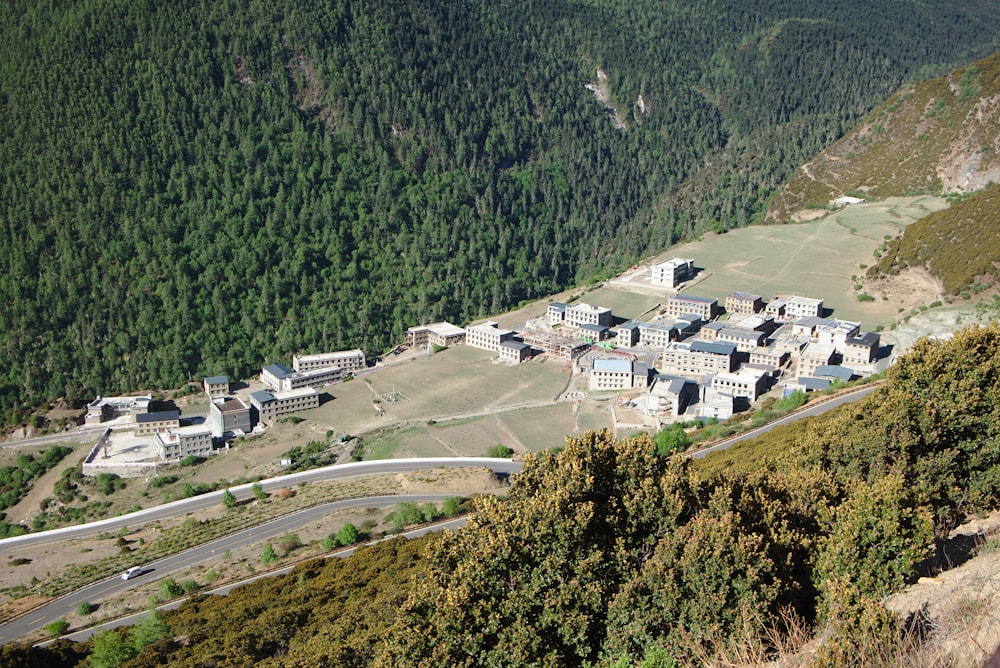 an aerial view of a large building in the middle of a mountain