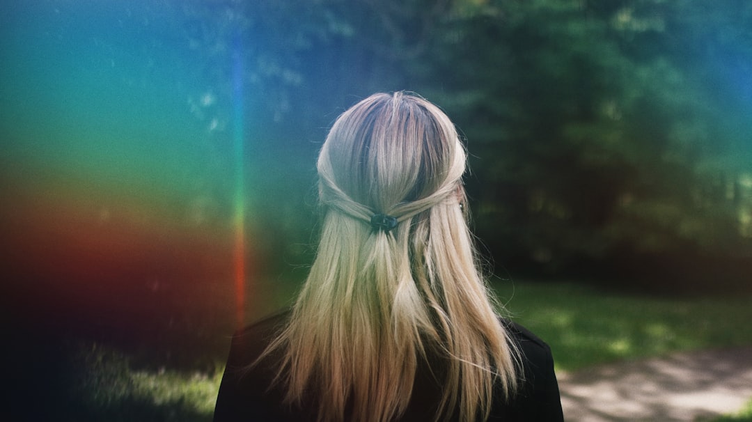 woman in black shirt standing on green grass field during daytime