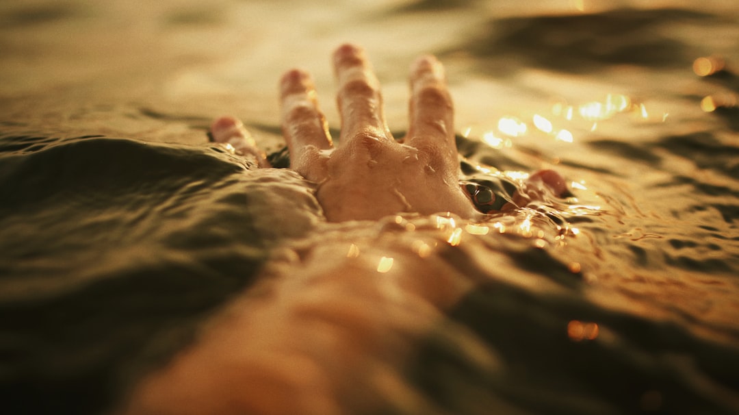 Hand reaching out in the water