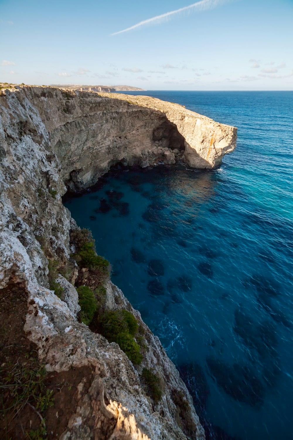 brown and gray rock formation beside blue sea during daytime