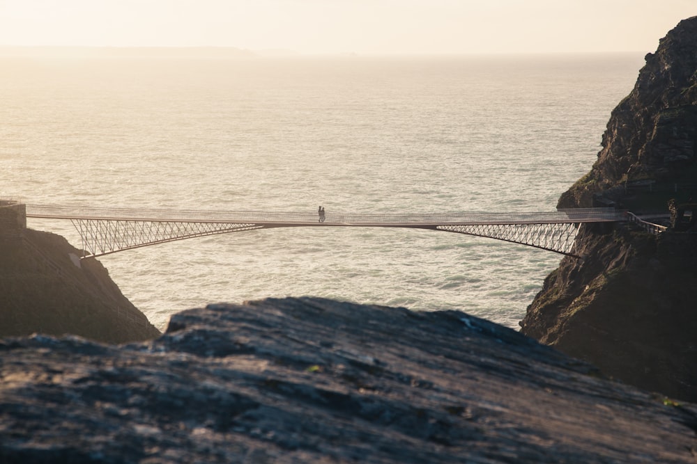 white bridge on body of water during daytime