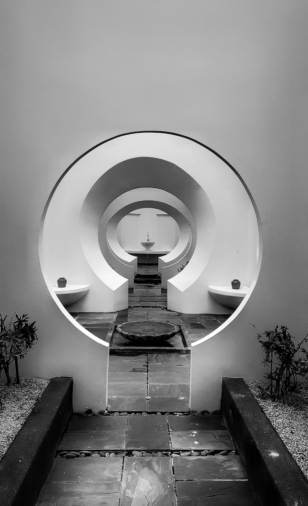 grayscale photo of round tunnel