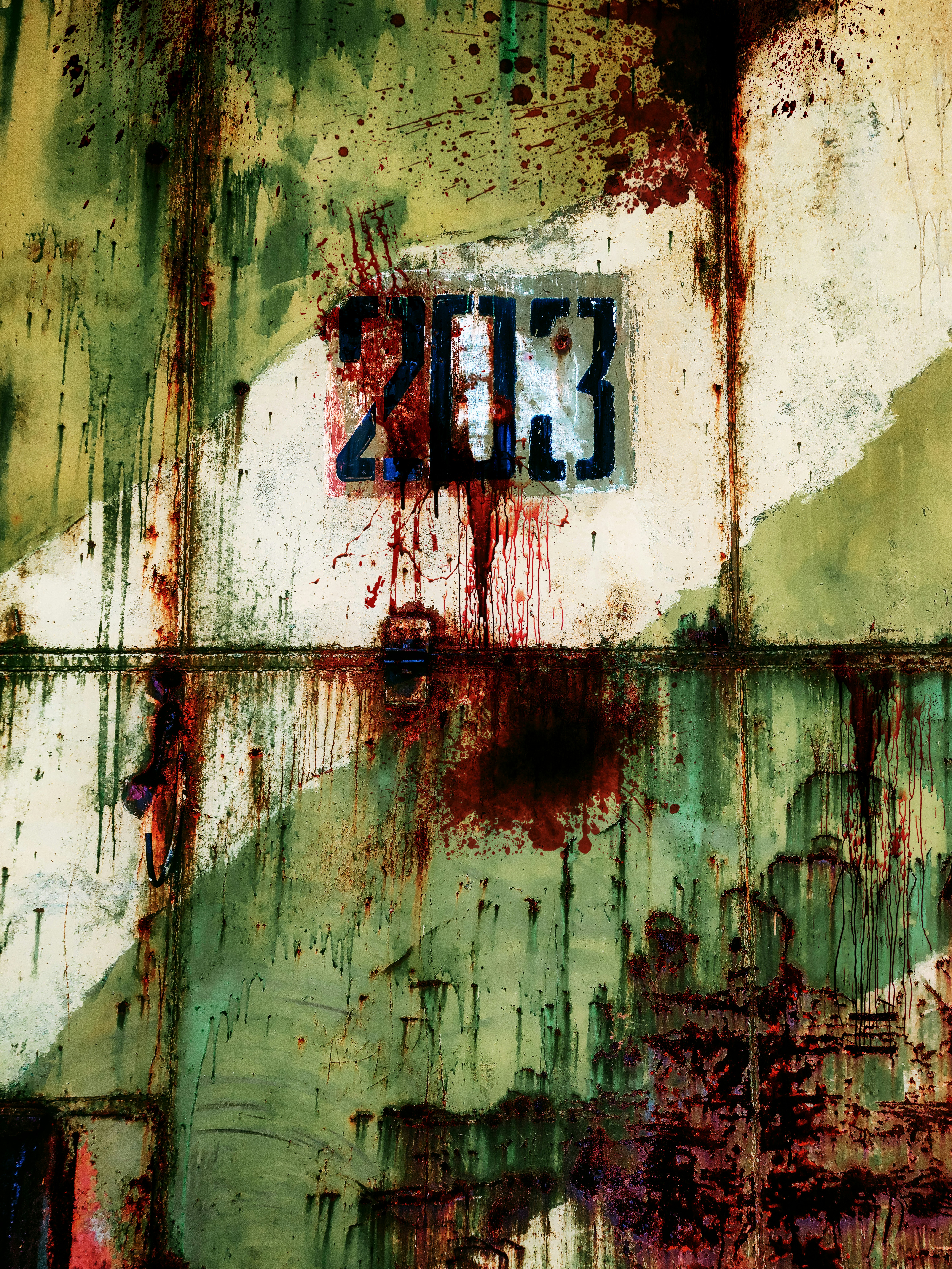 Old vintage metal texture with number or inscription 203, rust, blood and scratches. Soviet military protective paint and blood spatter. Ancient military inscription with blood spatter. The dark green, red and yellow door of the soviet aircraft hangar.