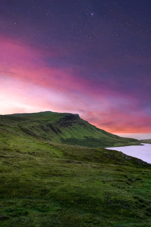 green mountain under purple sky