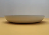 Minimalist kraft bowl with smooth edges displayed on a plain white surface