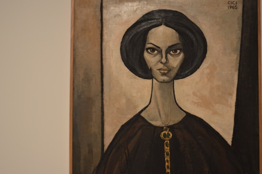 A portrait painting of a woman with distinct facial features, elongated neck, and dark hair. The background and her clothing have muted earth tones, creating a vintage and somewhat timeless appearance.