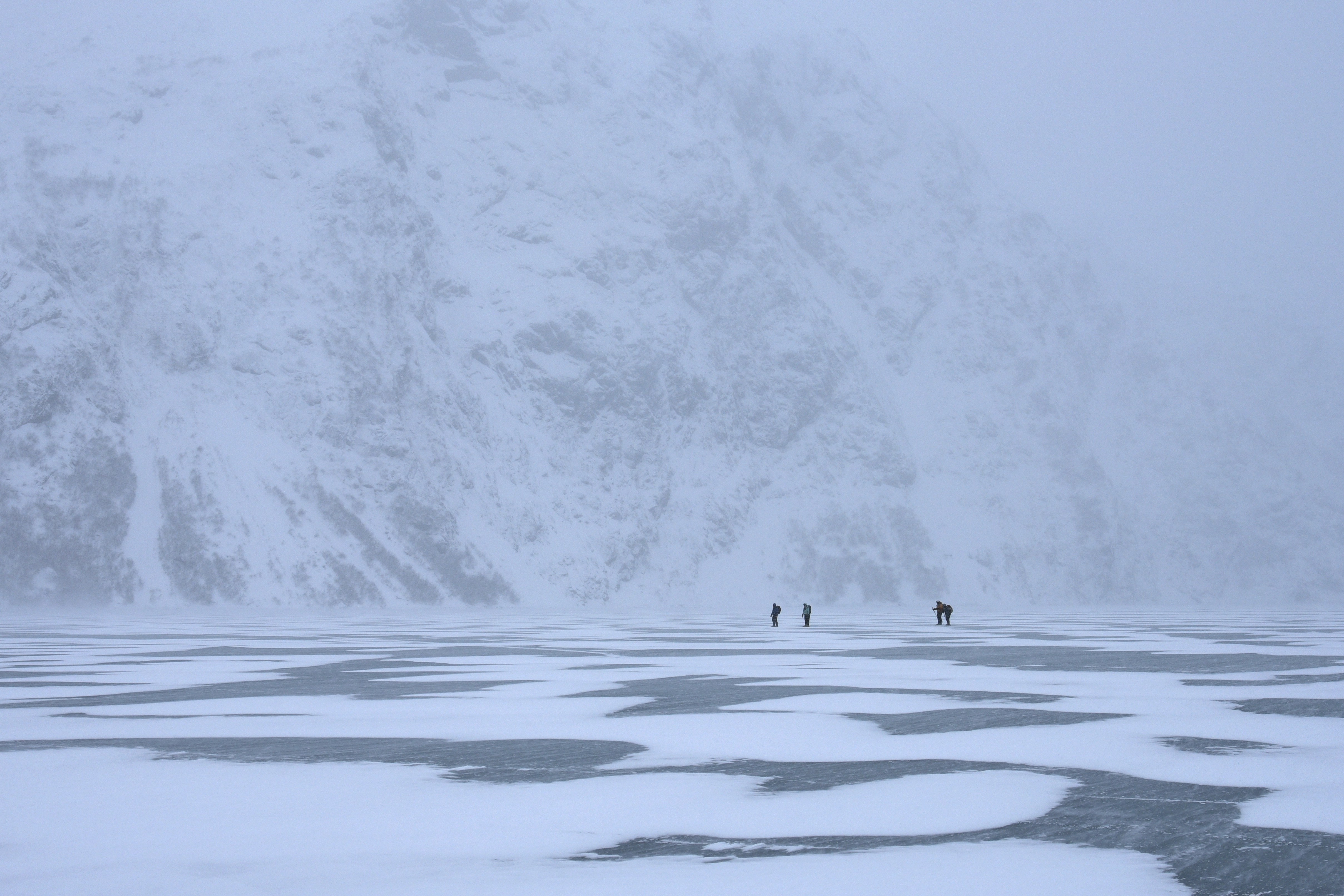 person walking on snow covered field during daytime