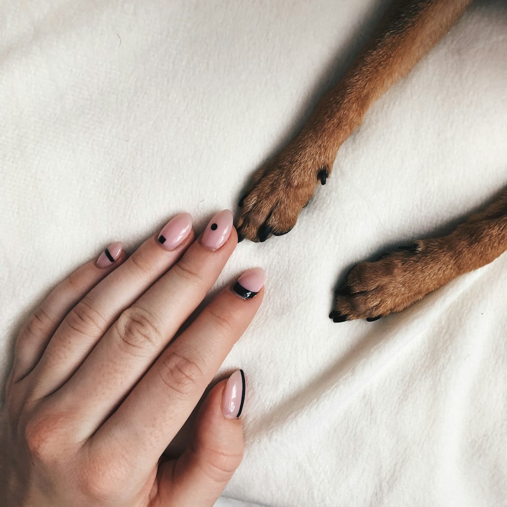 persons hand on white textile