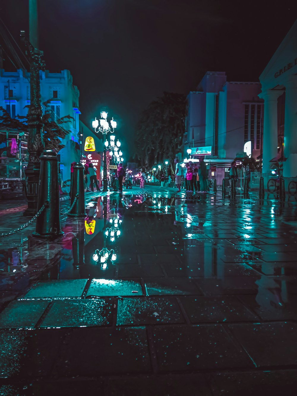 people walking on sidewalk during night time