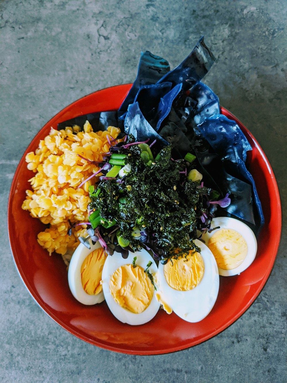 sliced lemon and green vegetable salad on red ceramic bowl