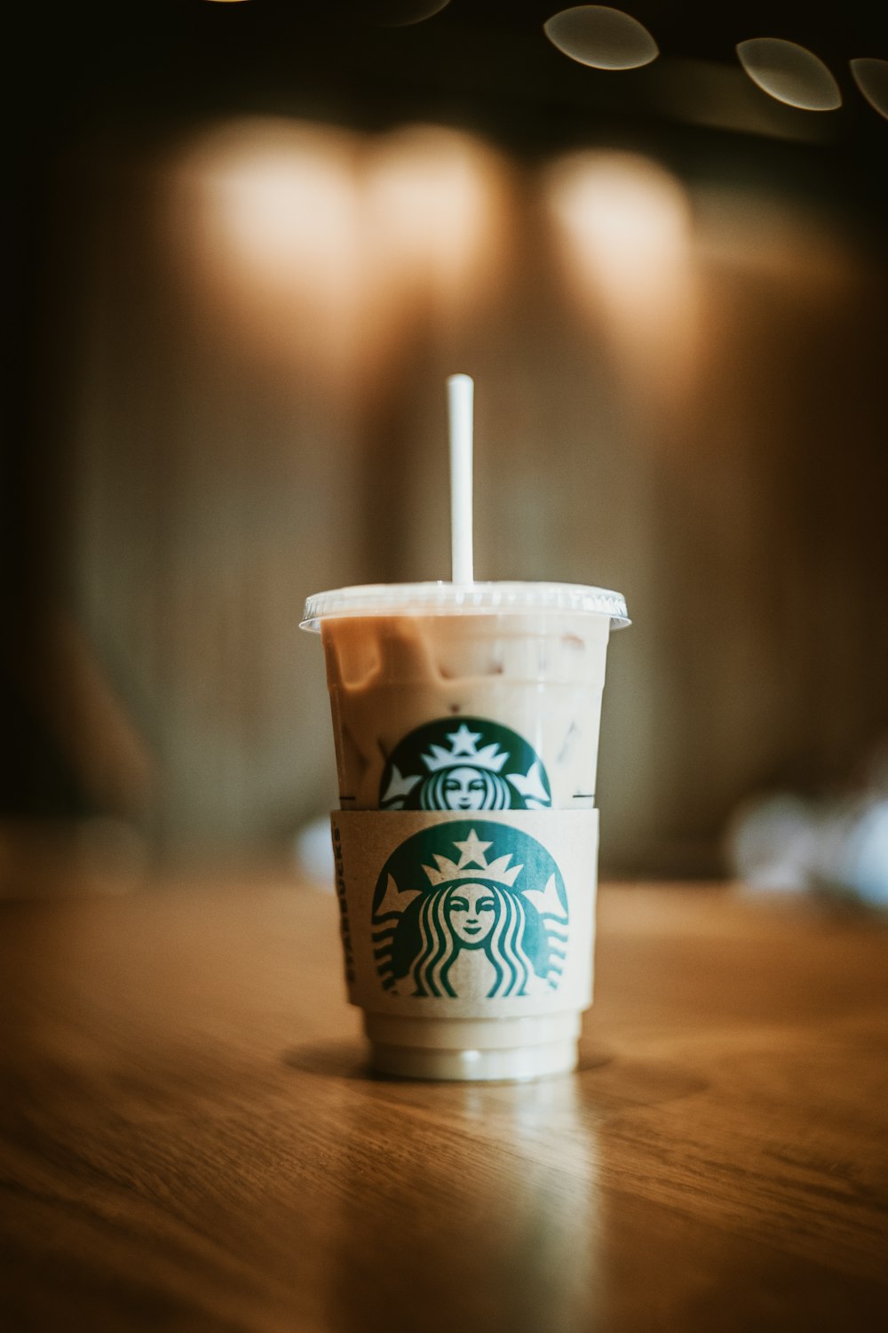 white and brown starbucks disposable cup