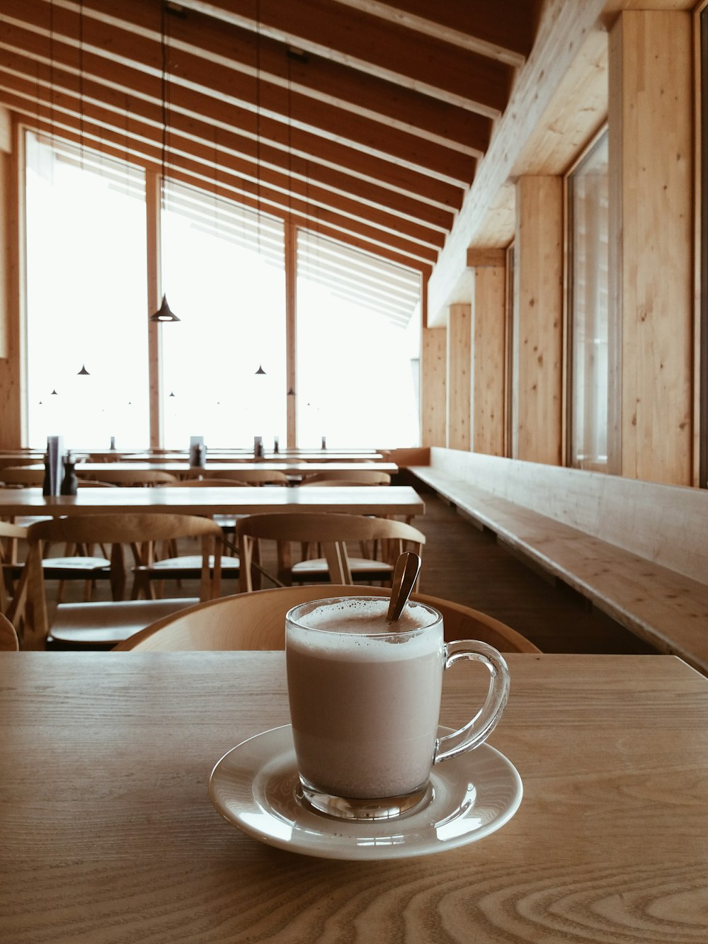 white ceramic mug on brown wooden table