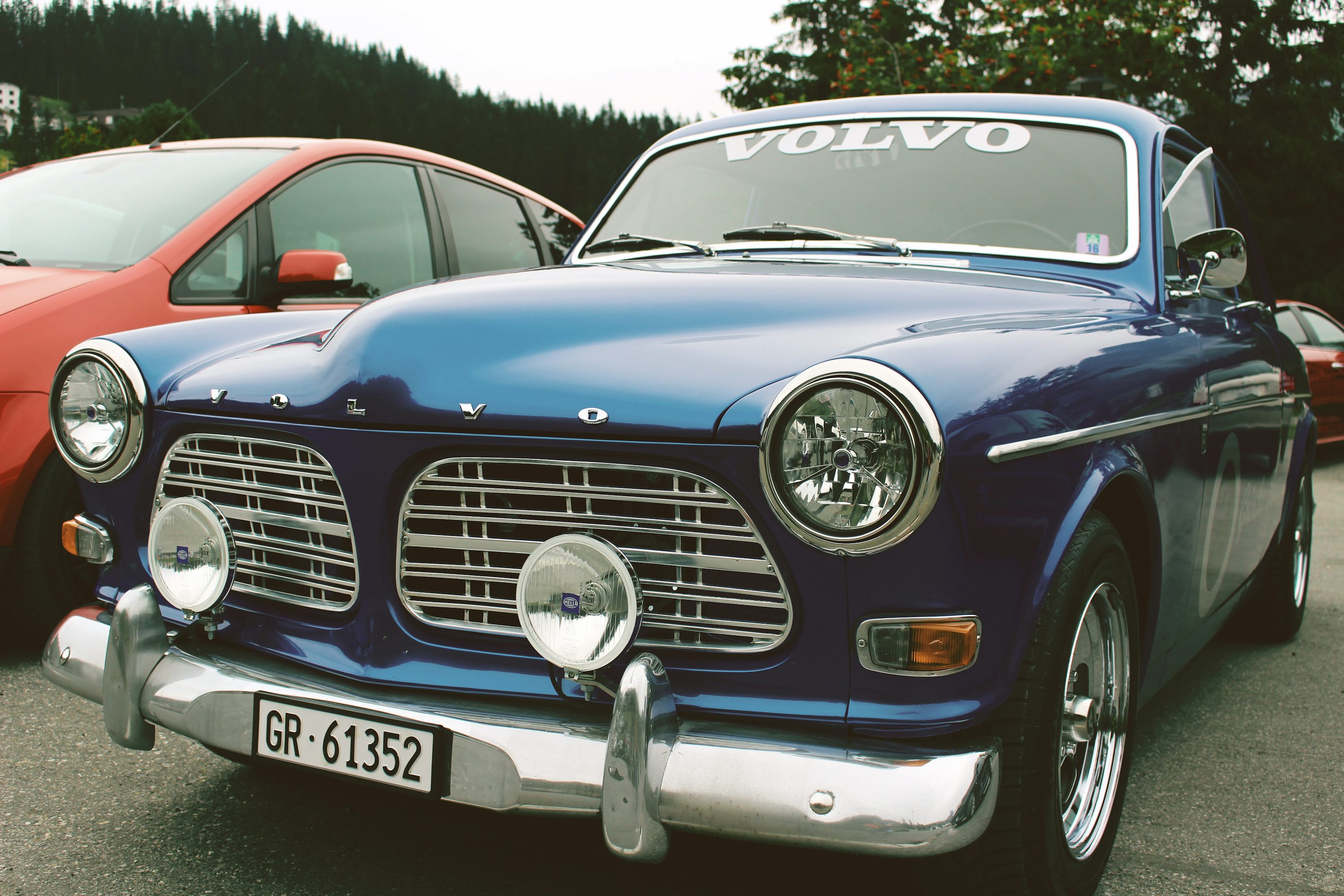 blue mercedes benz car on parking lot during daytime