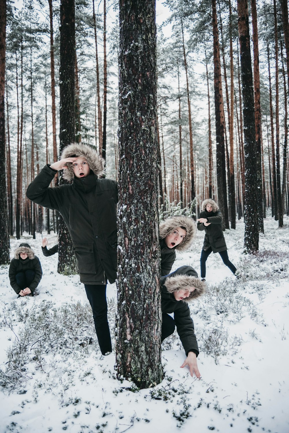 woman in black jacket standing beside brown tree trunk during daytime