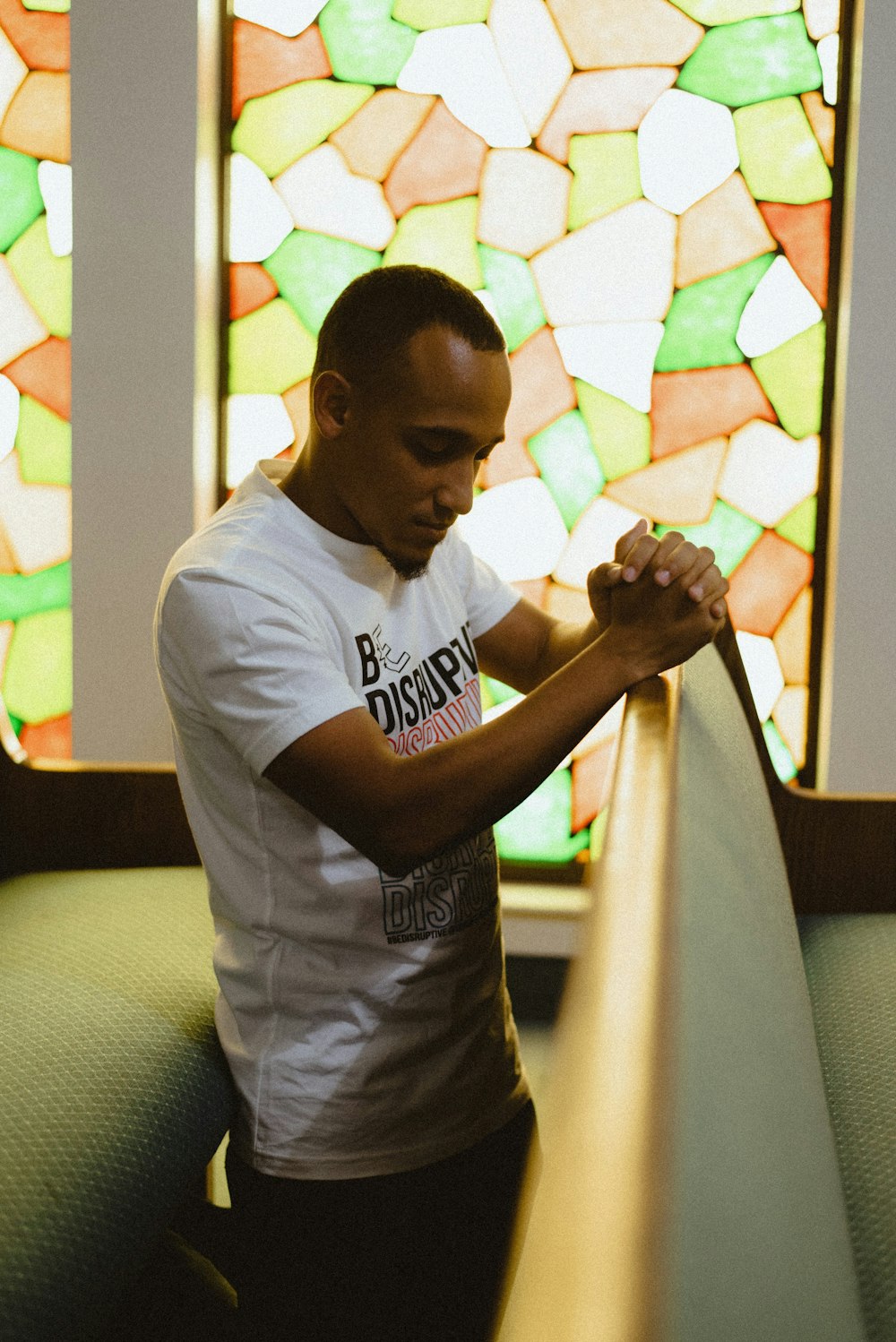 man in white crew neck t-shirt and gray pants holding white textile