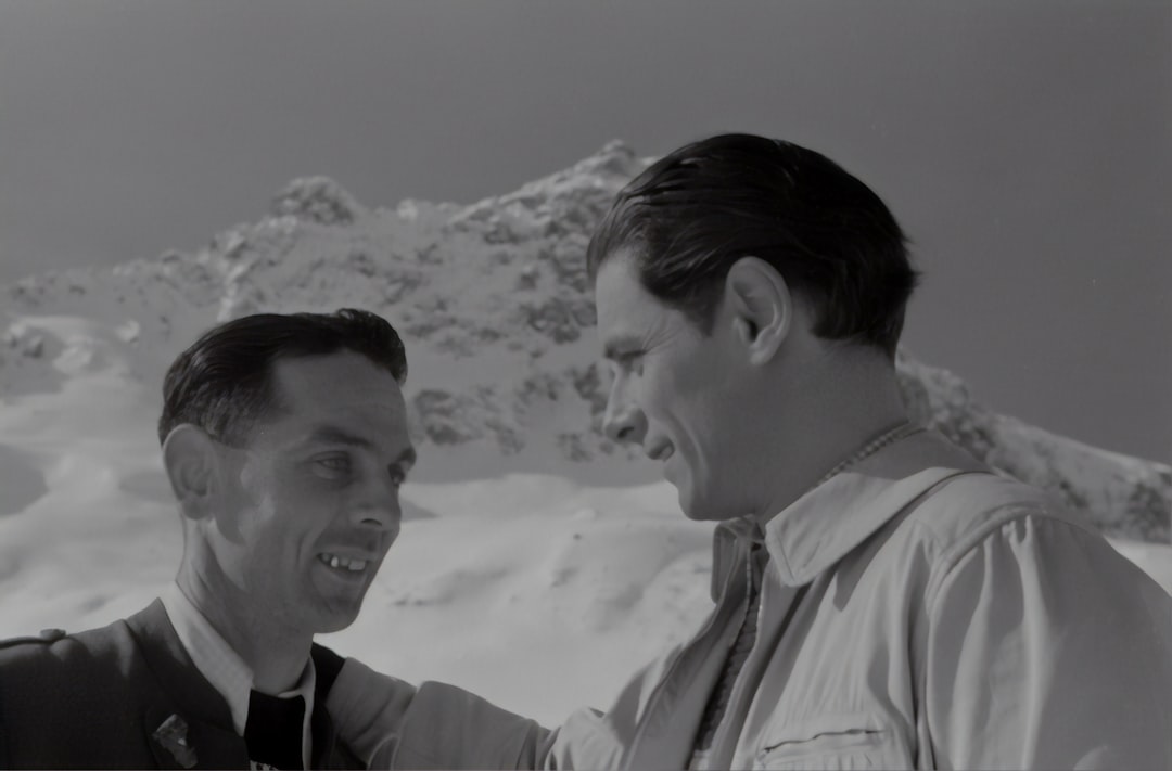 man in white dress shirt beside woman in black and white stripe shirt, Film by Géza von Cziffra. Rudolf Prack on the right.