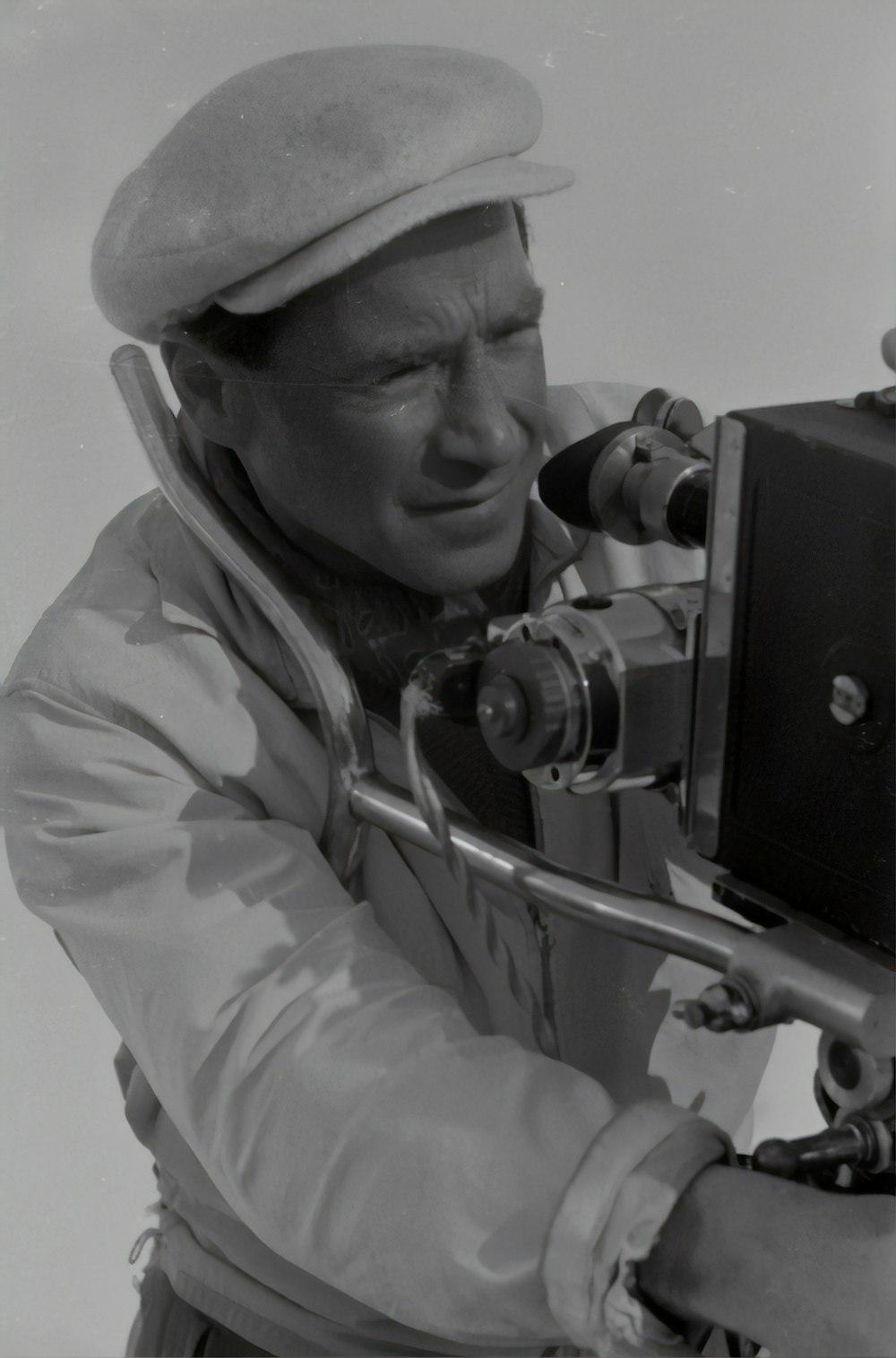 man in gray jacket using black dslr camera