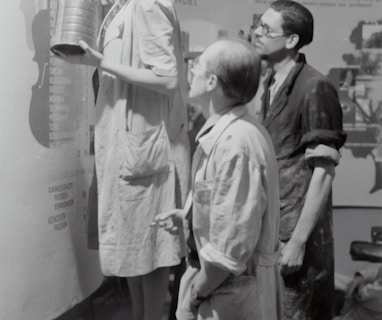 grayscale photo of man and woman standing beside boy