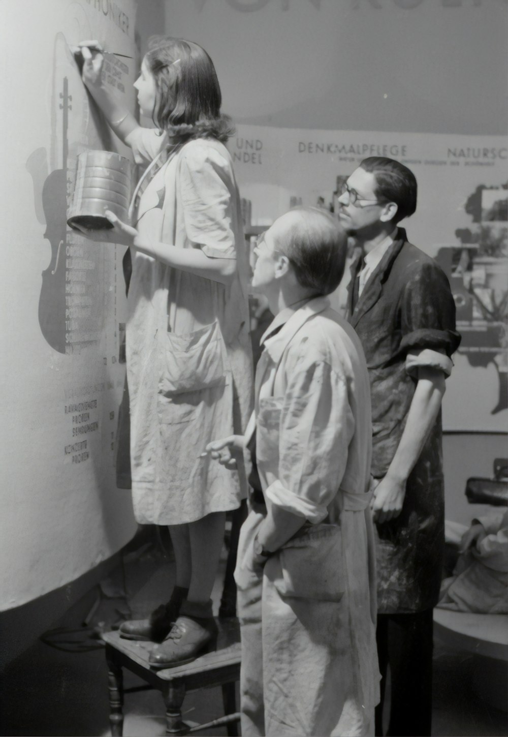 grayscale photo of man and woman standing beside boy