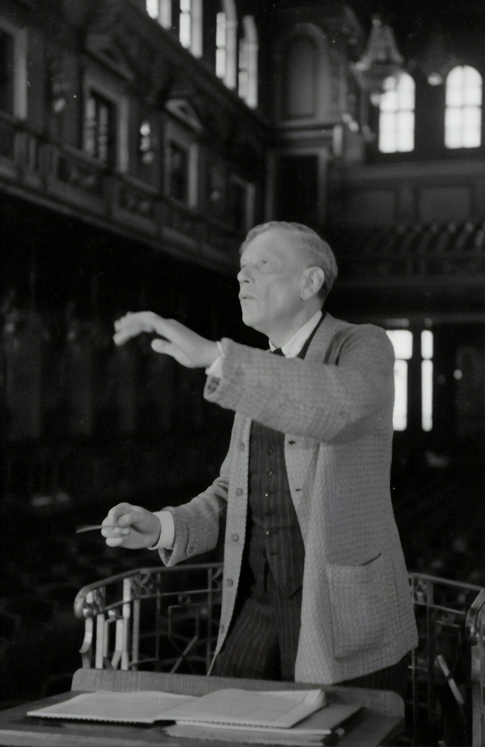 man in gray suit jacket holding a microphone