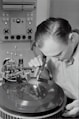 boy in white dress shirt holding silver round tool