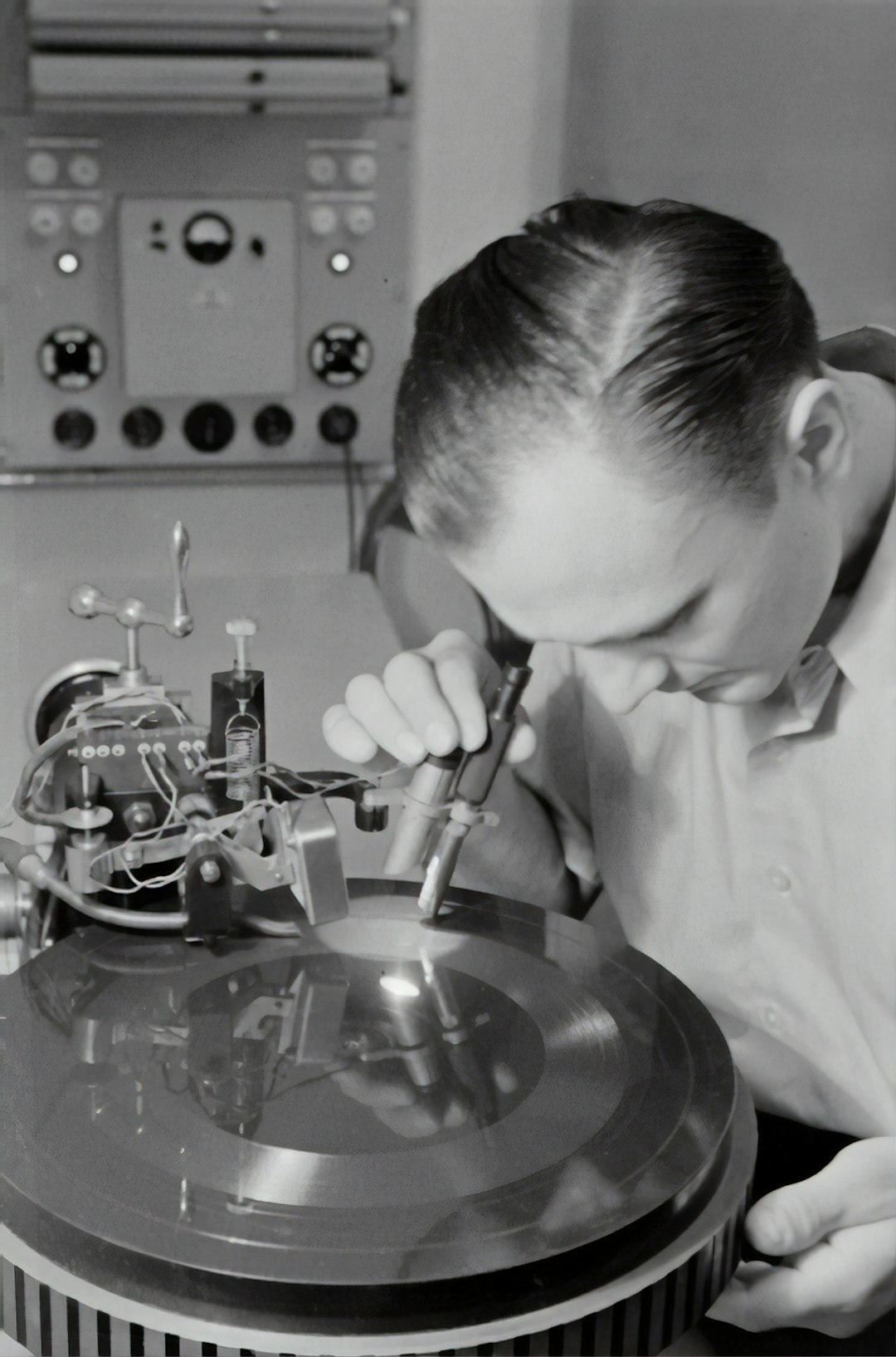  boy in white dress shirt holding silver round tool record player