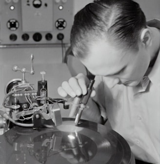 boy in white dress shirt holding silver round tool