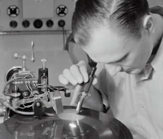 boy in white dress shirt holding silver round tool