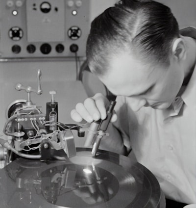 boy in white dress shirt holding silver round tool