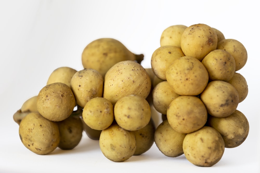 yellow round fruits on white surface