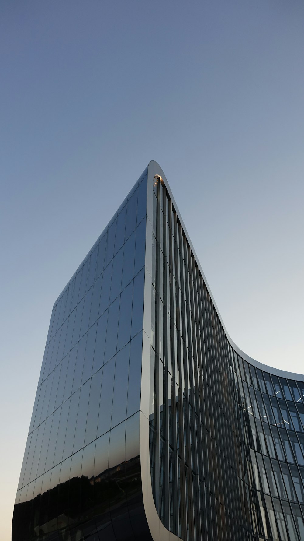 blue glass walled high rise building