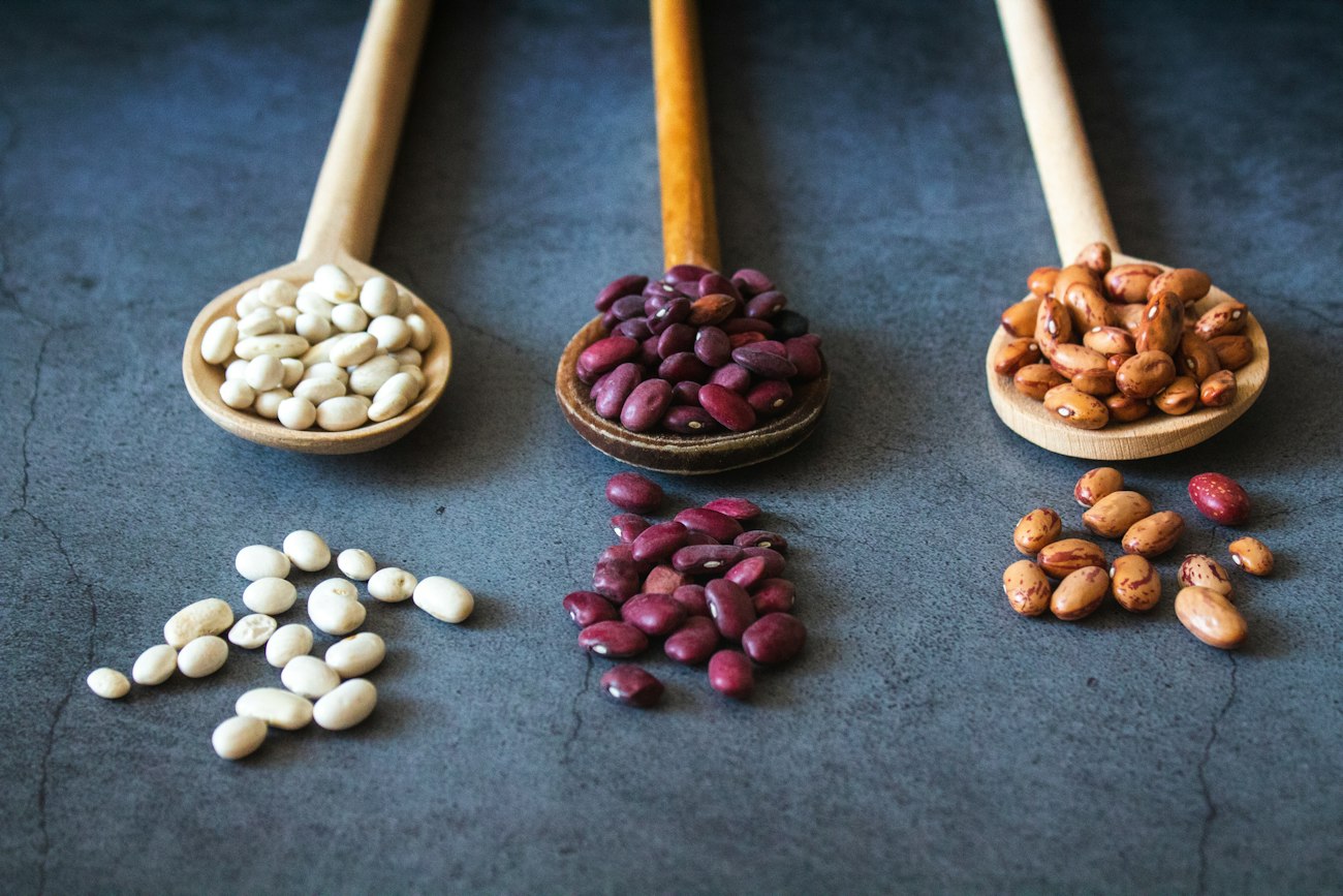 Several varieties of dried beans in bowls