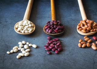 brown wooden spoon with red and brown beans