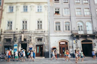 A group of happy travelers exploring colorful streets of a historic city.