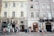 A group of friends exploring a vibrant city street filled with culture and architecture.