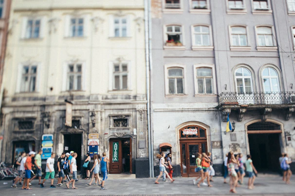 Group of happy tourists enjoying a guided city tour with colorful buildings in the background