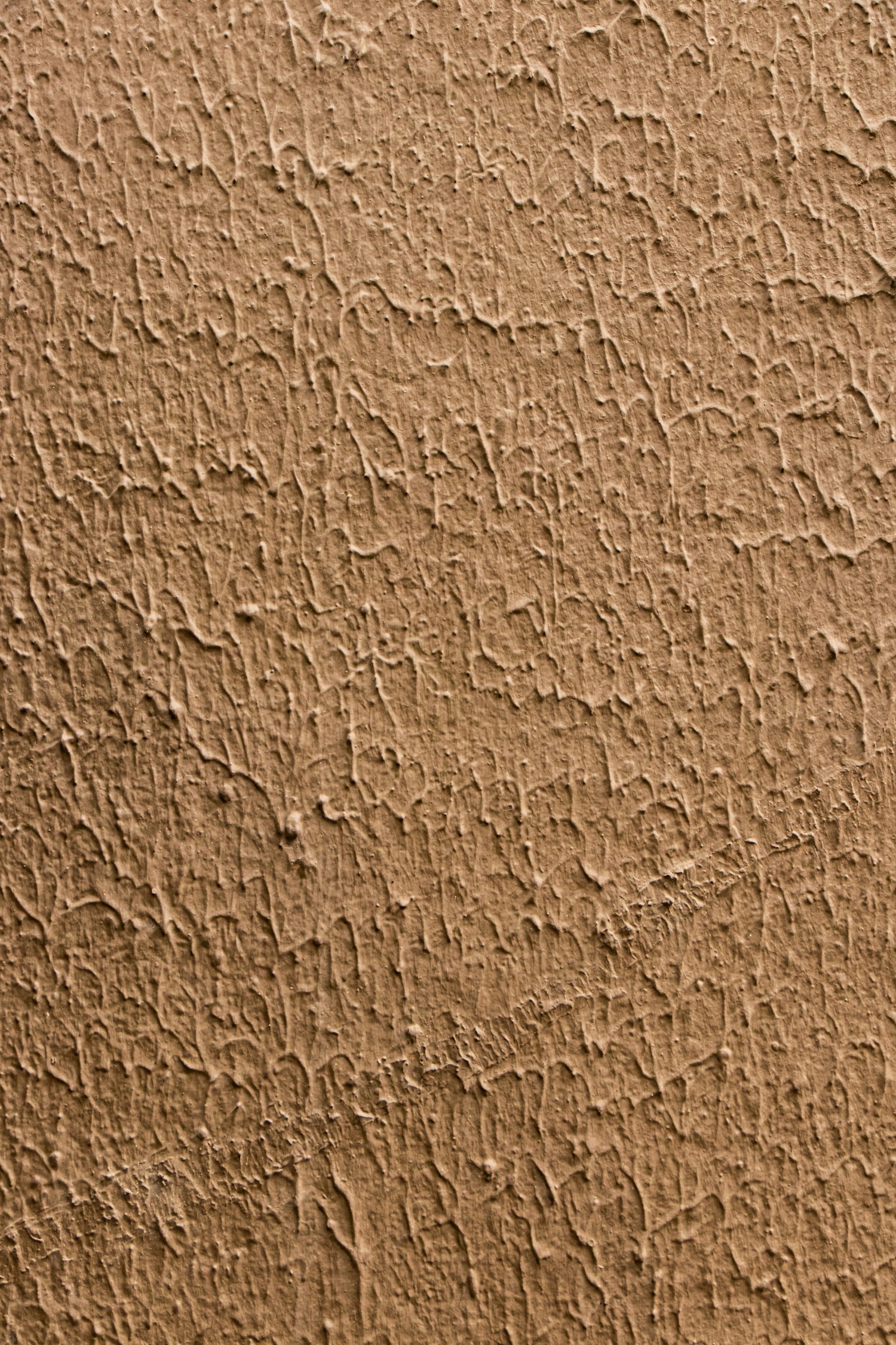 Close up texture of rammed earth wall showing natural stratified layers of compacted clay, sand, and gravel