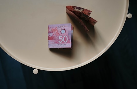 100 banknote on white round table
