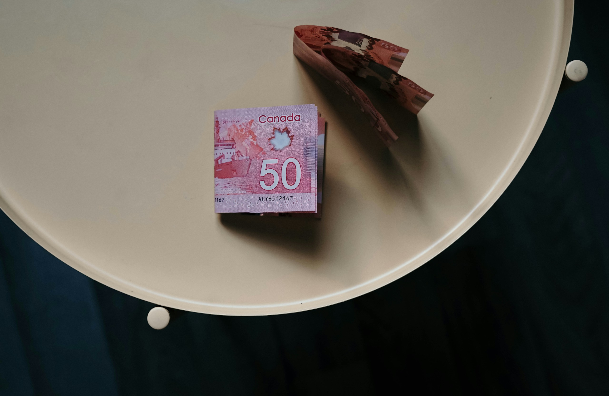 100 banknote on white round table