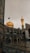 A beautiful architectural structure featuring an ornate golden dome and a tall, intricately designed minaret. The building is adorned with blue and gold tiles and arches, reflecting traditional Islamic architecture. The courtyard is paved with stones that glisten under the light, creating a serene and majestic atmosphere.