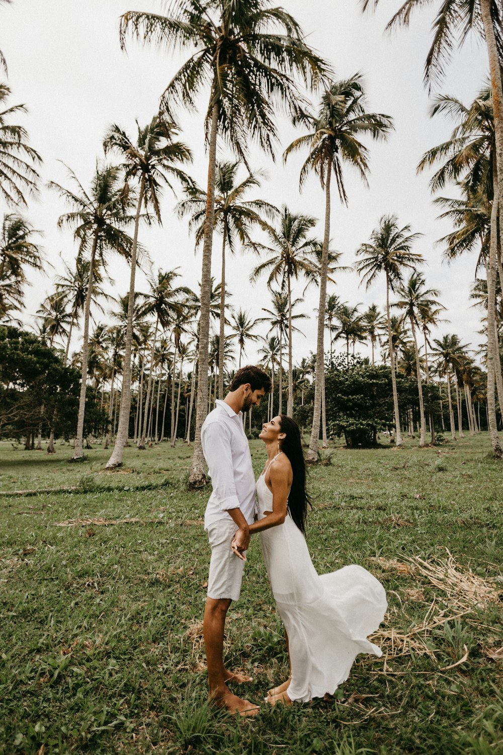 man and woman kissing on green grass field during daytime