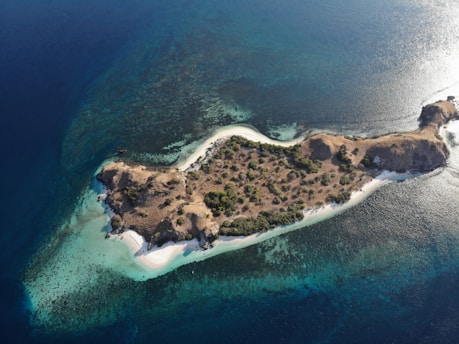 A breathtaking view of Gili Iyang island showcasing its lush greenery and clear blue waters.