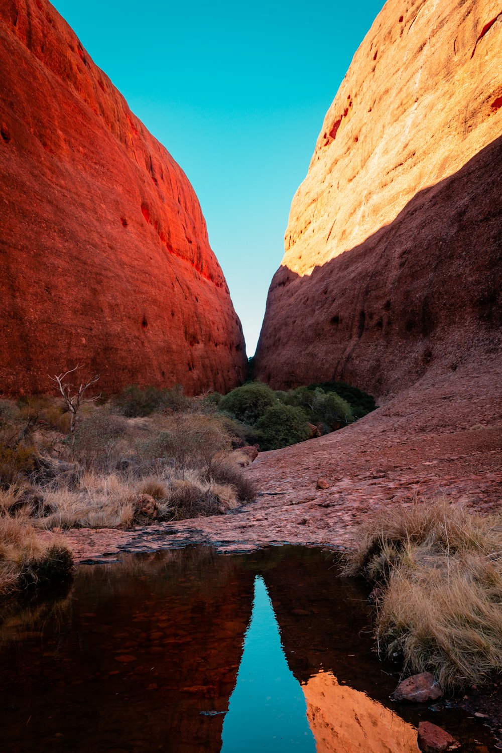 brown rock formation near body of water during daytime