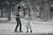 Smiling boy and girl walking hand in hand wearing trendy shoes