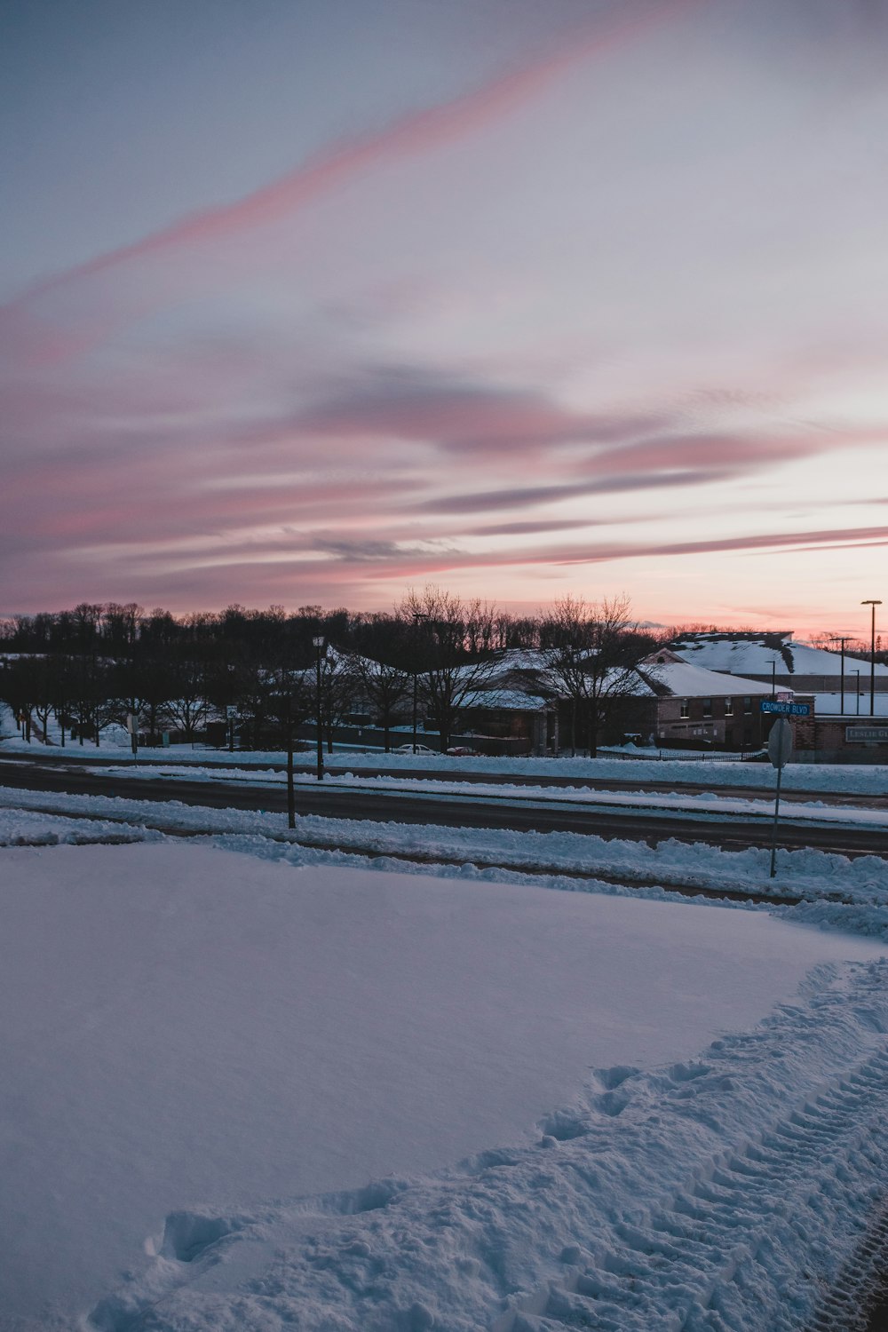 snow covered field during sunset