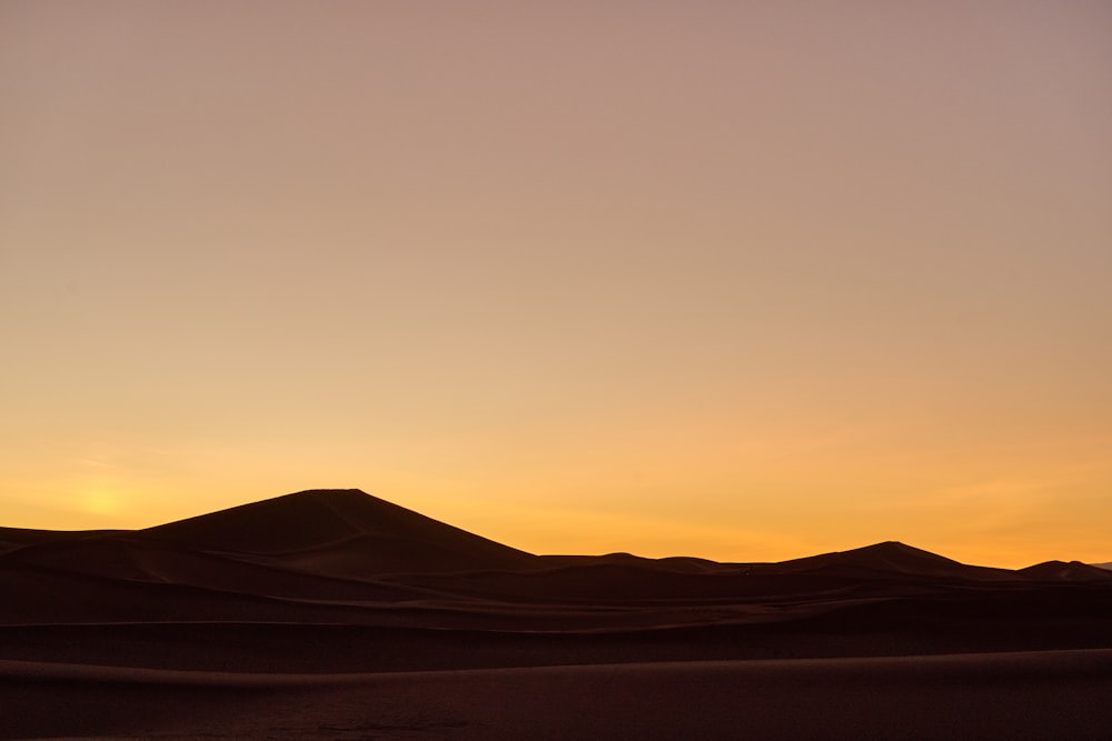 silhouette of mountain during sunset