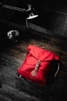 red leather handbag on wooden floor