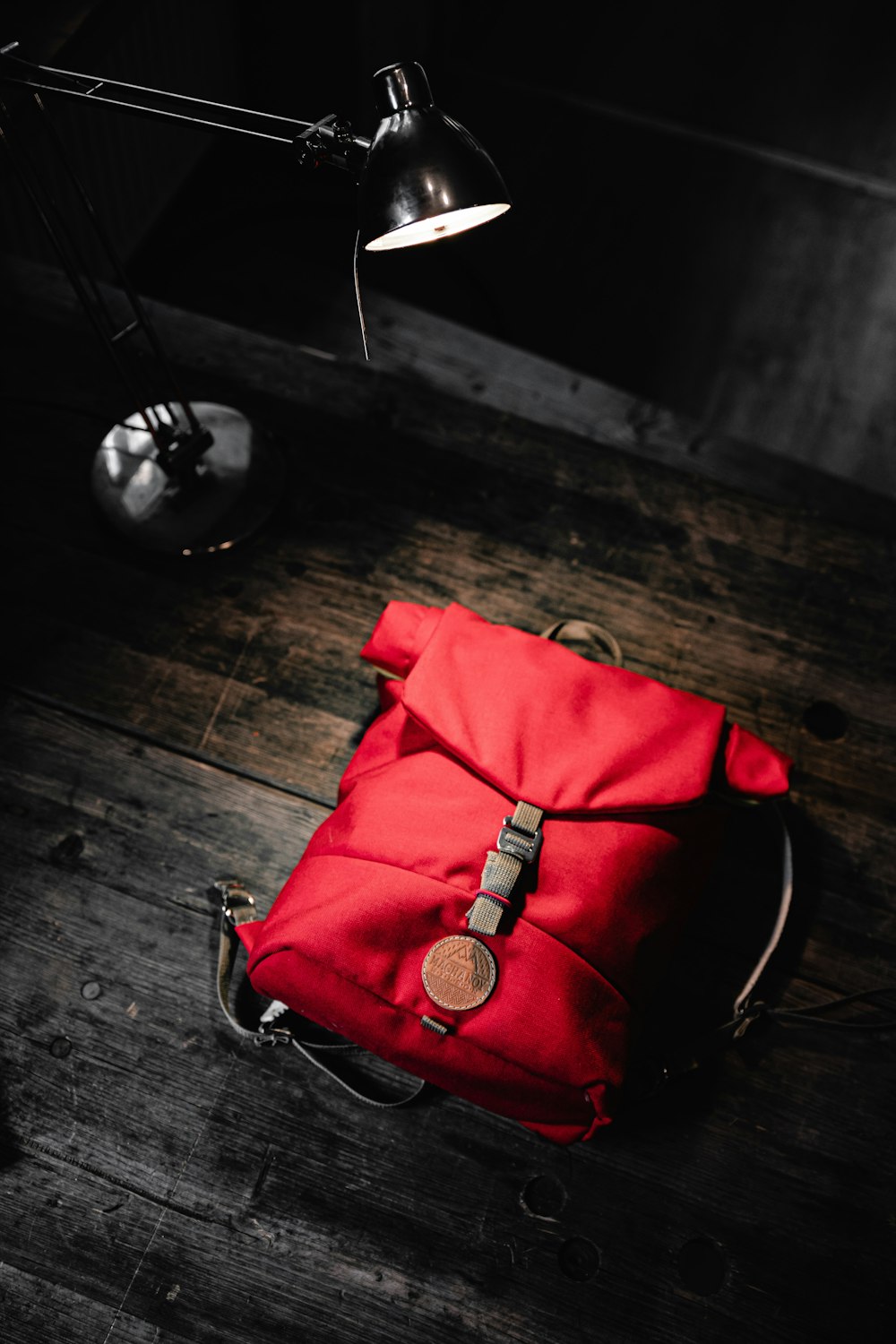 red leather handbag on wooden floor
